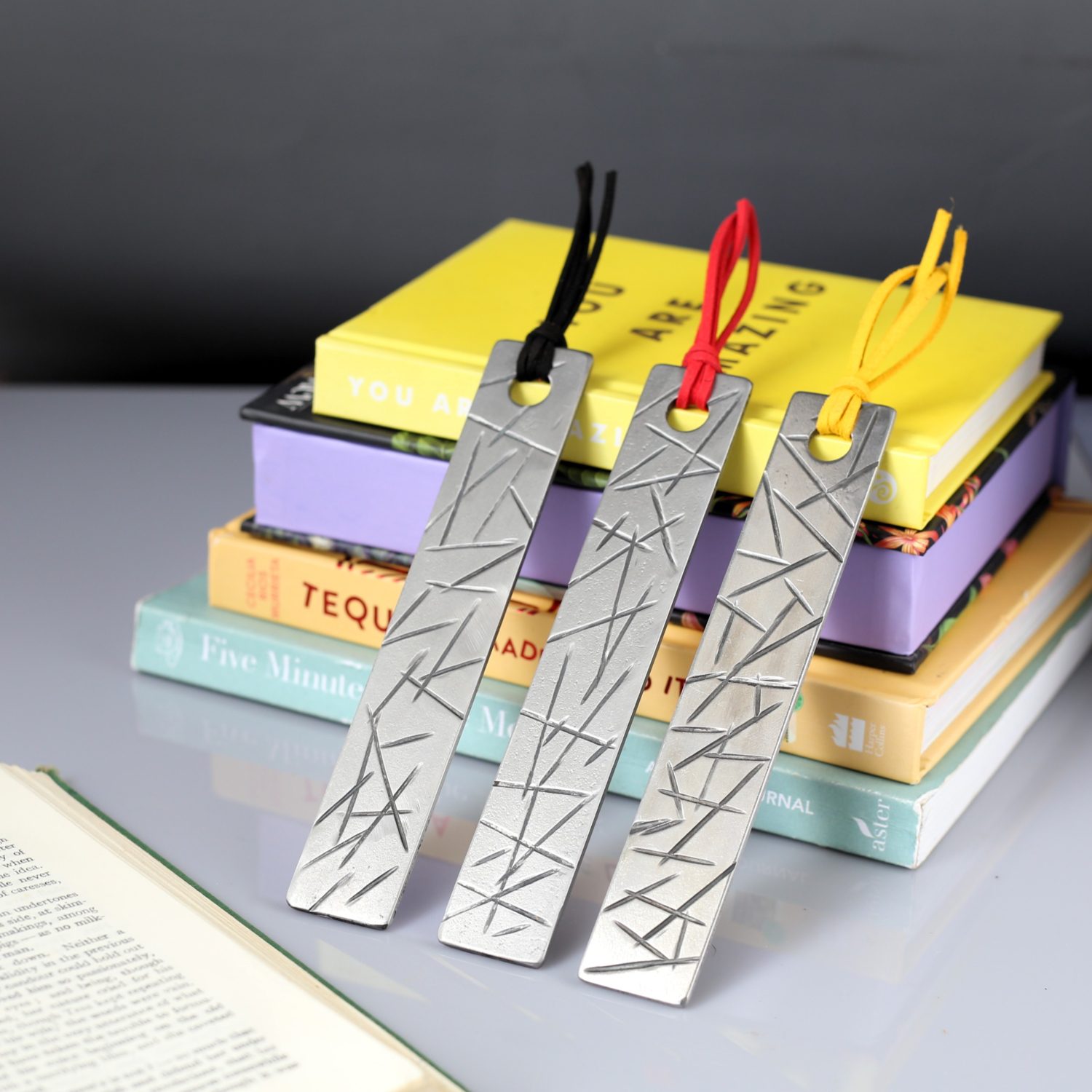 A selection of metal bookmarks with coloured tassels